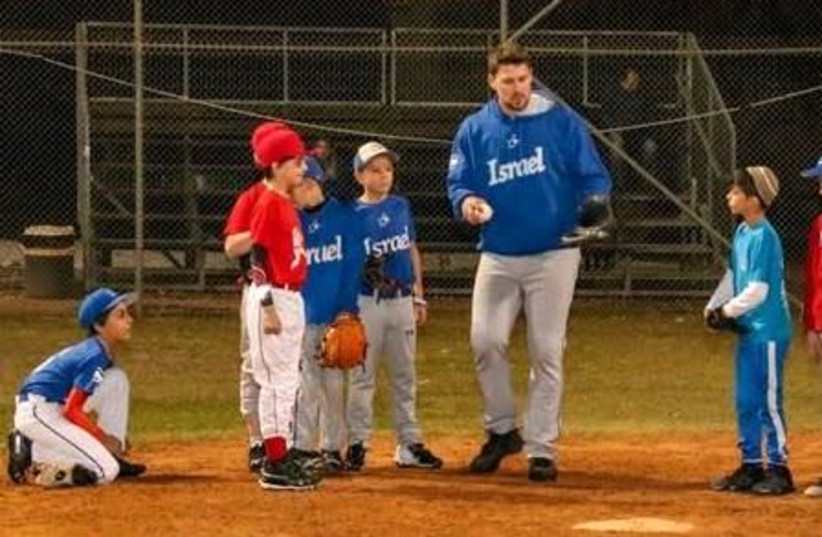 MAJOR LEAGUER and Israel Olympic National Team catcher Ryan Lavarnway (center) coaches young Israeli baseball players at the Baptist Village in 2019. (photo credit: Courtesy)