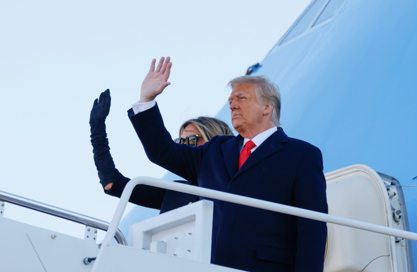 US President Donald Trump and first lady Melania Trump wave as they board Air Force One at Joint Base Andrews, Maryland, US, January 20, 2021. (photo credit: CARLOS BARRIA / REUTERS)