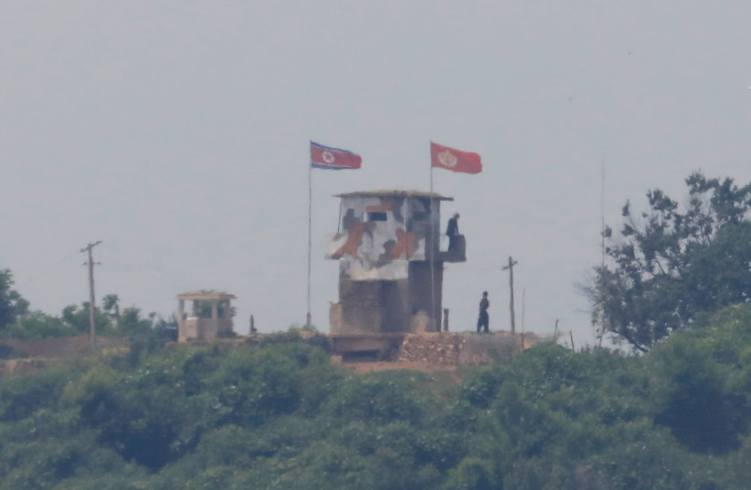 North Korean soldiers are seen at their guard post inside North Korean territory, in this picture taken from Paju, South Korea, near the demilitarized zone (DMZ) separating the two Koreas, June 17, 2020 (photo credit: REUTERS/KIM HONG-JI)