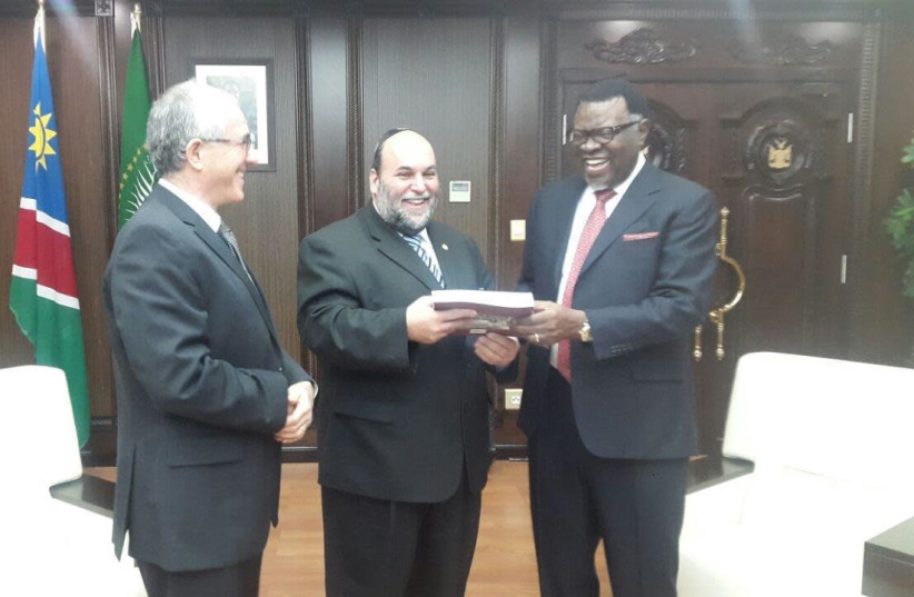 After non-resident Israeli Ambassador Gershon Kedar presented his credentials at State House in Windhoek, Rabbi Moshe Silberhaft hands Namibia’s President Hage Geingob a copy of the book, ‘The Jewish Community of South West Africa Namibia: A History. (photo credit: COURTESY RABBI SILBERHAFT)