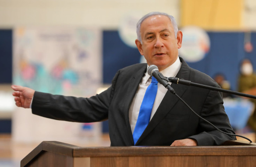 Prime Minister Benjamin Netanyahu is seen speaking at a COVID-19 vaccination center in Sderot, on January 27, 2021. (photo credit: LIRON MOLDOVAN/POOL)