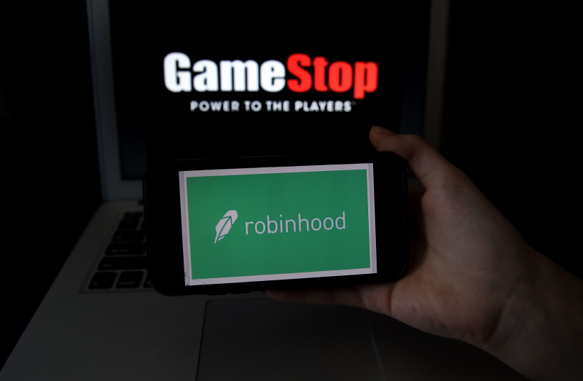 Investors have used the Robinhood app to give the video game company GameStop a boost.  (photo credit: OLIVIER DOULIERY/AFP VIA GETTY IMAGES)