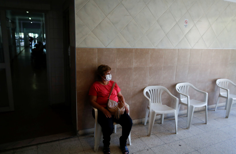 A woman waits to be vaccinated with the second dose of the Sputnik V (Gam-COVID-Vac) vaccine at the San Martin hospital, in La Plata, on the outskirts of Buenos Aires, Argentina January 21, 2021. (photo credit: REUTERS/AGUSTIN MARCARIAN)
