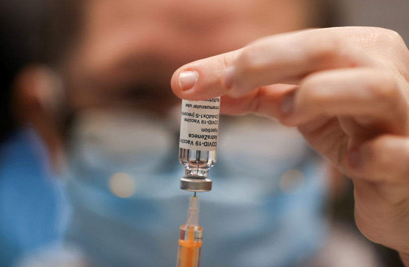 A health worker draws a dose of the AstraZeneca's coronavirus disease (COVID-19) vaccine, at the vaccination center in the Newcastle Eagles Community Arena, in Newcastle upon Tyne, Britain, January 30, 2021. (photo credit: REUTERS/LEE SMITH)