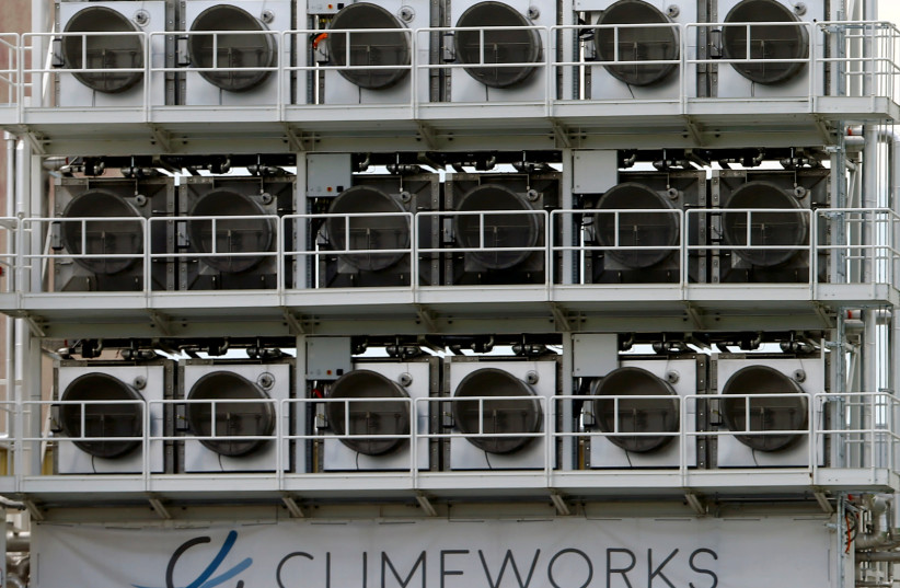 A facility for capturing CO2 from air of Swiss Climeworks AG is placed on the roof of a waste incinerating plant in Hinwil, Switzerland July 18, 2017.  (photo credit: ARND WIEGMANN / REUTERS)