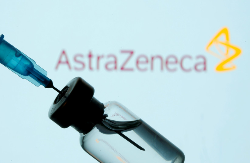 A vial and sryinge are seen in front of a displayed AstraZeneca logo in this illustration taken January 11, 2021 (photo credit: DADO RUVIC/REUTERS)