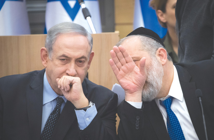 Prime Minister Benjamin Netanyahu speaks with the Shas party chairman, Interior Minister Arye Deri, during a meeting with heads of right-wing parties last year. (photo credit: YONATAN SINDEL/FLASH 90)