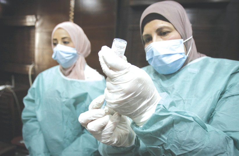 PALESTINIAN HEALTH WORKERS at a hospital in Nablus, where health workers were vaccinated against the coronavirus disease, after the delivery of vaccine doses from Israel earlier this month. (photo credit: NASSER ISHTAYEH/FLASH90)