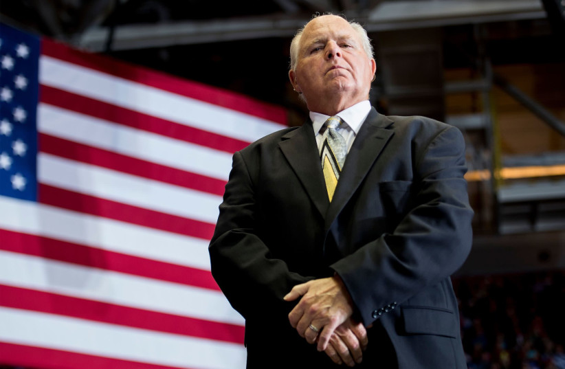 Rush Limbaugh looks on before introducing President Donald Trump at a rally in Cape Girardeau, Mo., Nov. 5, 2018. (photo credit: JIM WATSON/AFP VIA GETTY IMAGES)