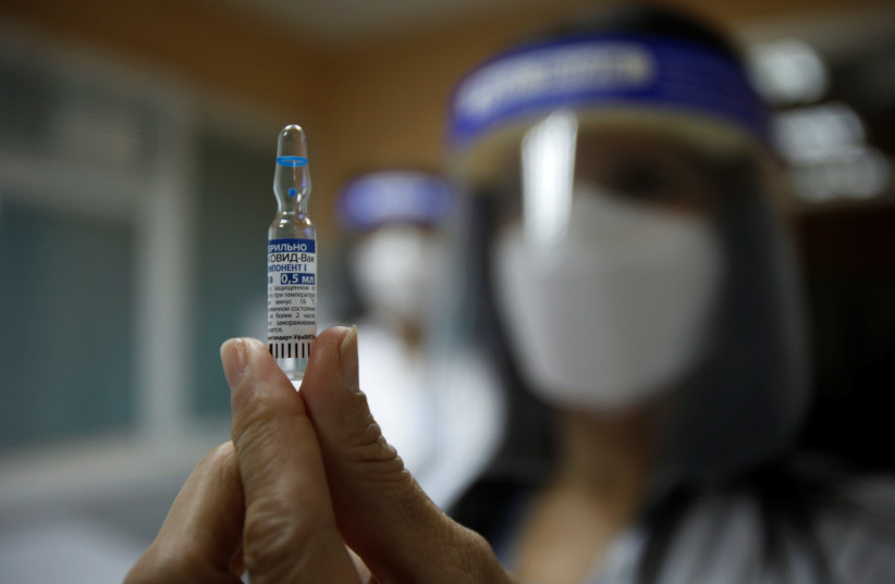 A healthcare worker shows an ampule with the Sputnik V coronavirus disease (COVID-19) vaccine in Podgorica, Montenegro, February 22, 2021. (credit: REUTERS)