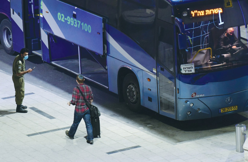 A PASSENGER SEARCHES for ground transportation after arriving at Ben-Gurion Airport earlier this month. (photo credit: TOMER NEUBERG/FLASH90)