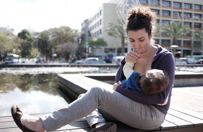 Israeli women take part at a Mass Breastfeeding as they gathered at Rabin Square in Tel Aviv on March 18, 2016, the idea  was to promote women's right to breastfeeding their babies in public, March 18, 2016. Photo by Tomer Neuberg/Flash90 (photo credit: TOMER NEUBERG/FLASH90)