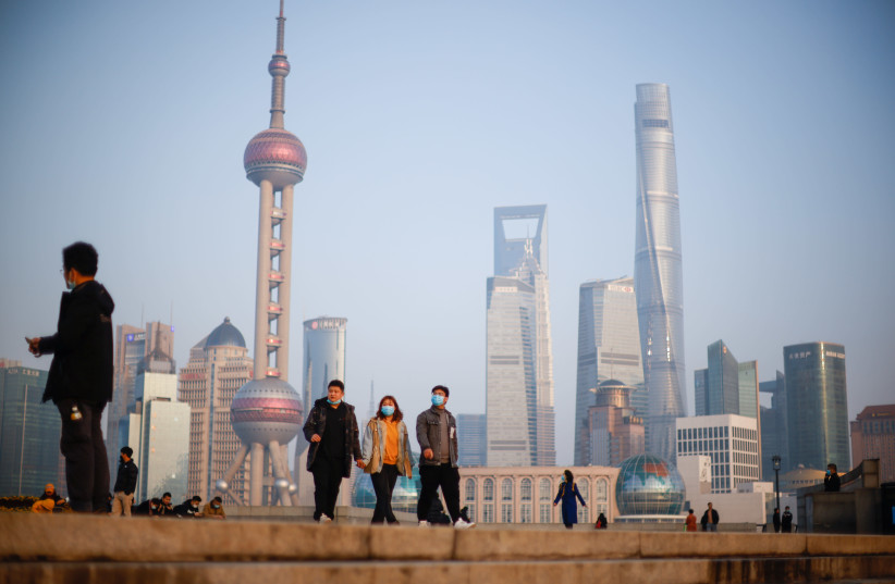 People walk at the Bund, in front of Lujiazui financial district of Pudong, Shanghai (photo credit: REUTERS/ALY SONG)