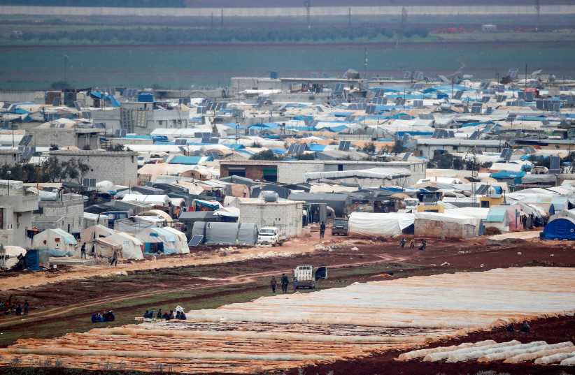 Tents housing internally displaced people in Atma camp in Idlib Governorate of Syria are seen on the Syrian side of the border zone near the Turkish village of Bukulmez in Hatay province, Turkey, February 24, 2020.  (credit: REUTERS/UMIT BEKTAS)