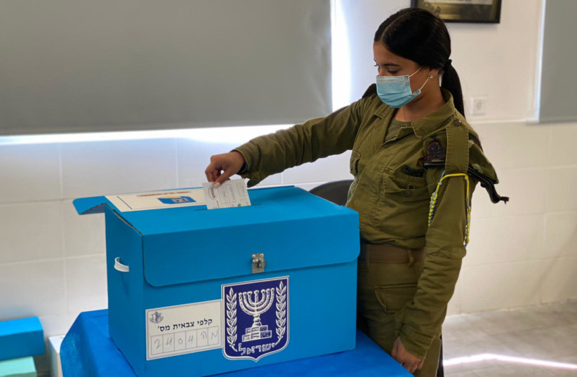 IDF soldier voting early for the 2021 elections (credit: IDF SPOKESPERSON'S UNIT)