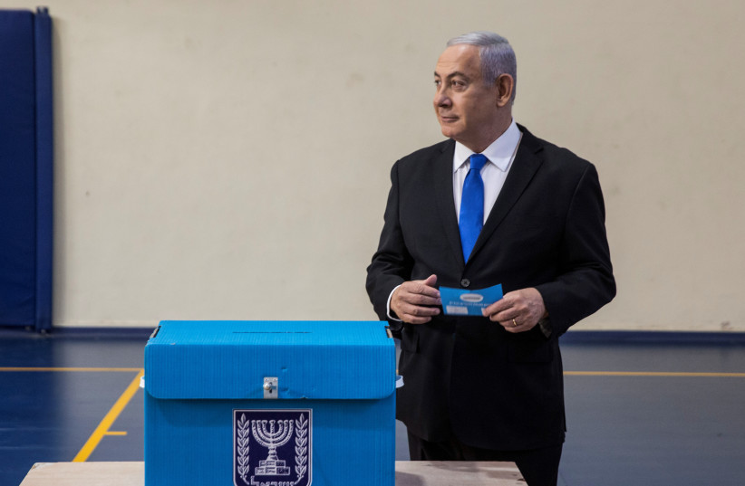 Prime Minister Benjamin Netanyahu votes  in the September 2019 election. (photo credit: HEIDI LEVINE/POOL/REUTERS)