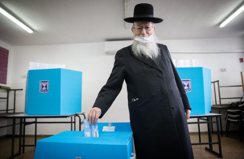 Construction and Housing Minister Ya’acov Litzman votes in Israel's March 23, 2021 election. (photo credit: YONATAN ZINDEL/FLASH 90)