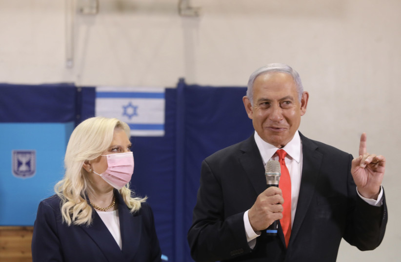 Prime Minister Benjamin Netanyahu and wife Sara Netanyahu at the ballot box for the 2021 elections (credit: MARC ISRAEL SELLEM/THE JERUSALEM POST)