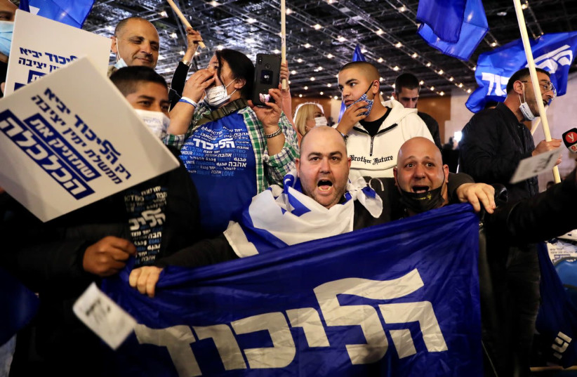 Likud supporters celebrate the exit polls, which give Prime Minister Benjamin Netanyahu a substantial lead. (photo credit: MARC ISRAEL SELLEM/THE JERUSALEM POST)
