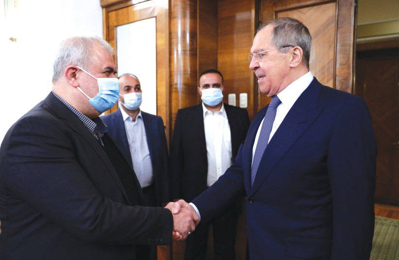 RUSSIA’S FOREIGN MINISTER Sergei Lavrov (right) shakes hands with Mohammad Raad, the head of the parliamentary bloc of Lebanon’s Hezbollah movement, during a meeting in Moscow earlier this month. (photo credit: RUSSIAN FOREIGN MINISTRY/REUTERS)