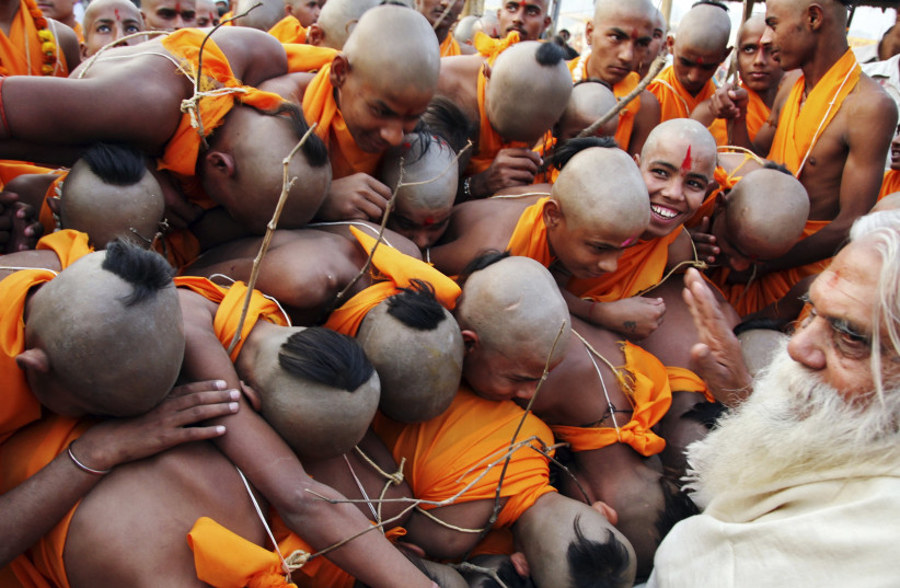 BOYS RECEIVE blessings from Swami Nitya Gopal Ji Mahar, a Hindu holyman in Allahabad, India. The author received guidance about how to forgive from a Hindu swami. (photo credit: REUTERS/JITENDRA PRAKASH)