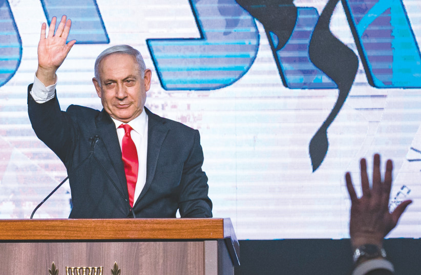 PRIME MINISTER Benjamin Netanyahu addresses supporters at Likud headquarters in Jerusalem on Wednesday morning.  (photo credit: MARC ISRAEL SELLEM/THE JERUSALEM POST)