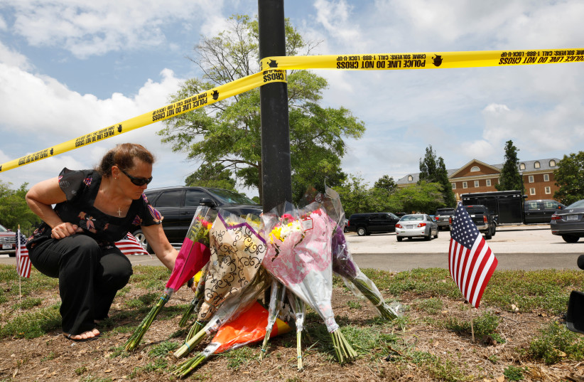 A resident places flowers at a makeshift memorial outside a municipal government building where a shooting incident occurred in Virginia Beach, Virginia, US June 1, 2019. (photo credit: REUTERS)