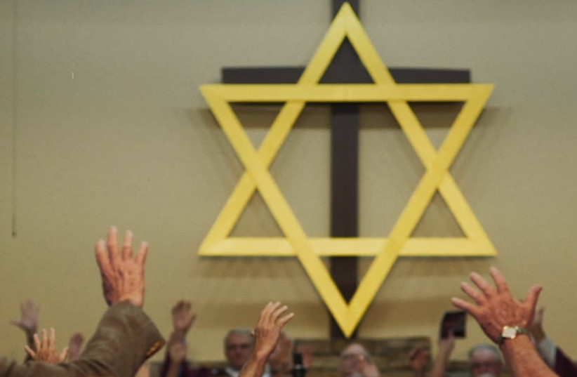 A church in Middlesboro, Kentucky, prays to a Star of David in a still from Maya Zinshtein's documentary '''Til Kingdom Come.'' (credit: ABRAHAM TROEN/'TIL KINGDOM COME (2019) FILM LTD.)