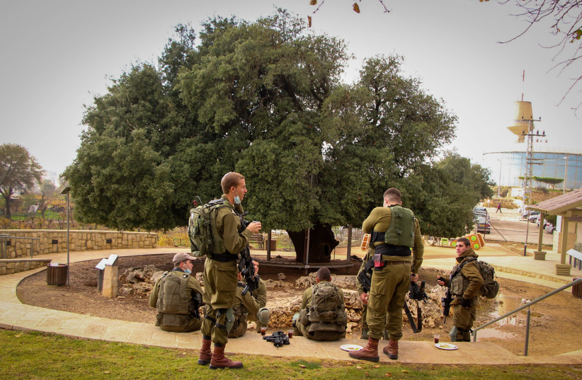 IDF SOLDIERS stop for lunch at the renovated compound of ‘The Lone Oak Tree,’ around a 700-year-old tree in Alon Shvut. (credit: GERSHON ELINSON/FLASH90)