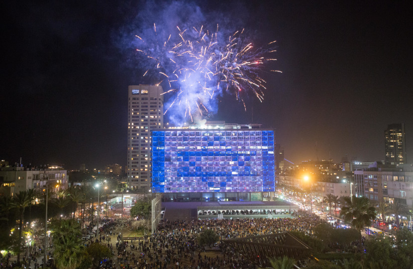 Israelis watch fireworks during a show to mark Israel's 73rd Independence Day, on Rabin square in Tel Aviv on April 14, 2021. (photo credit: MIRIAM ALSTER/FLASH90)