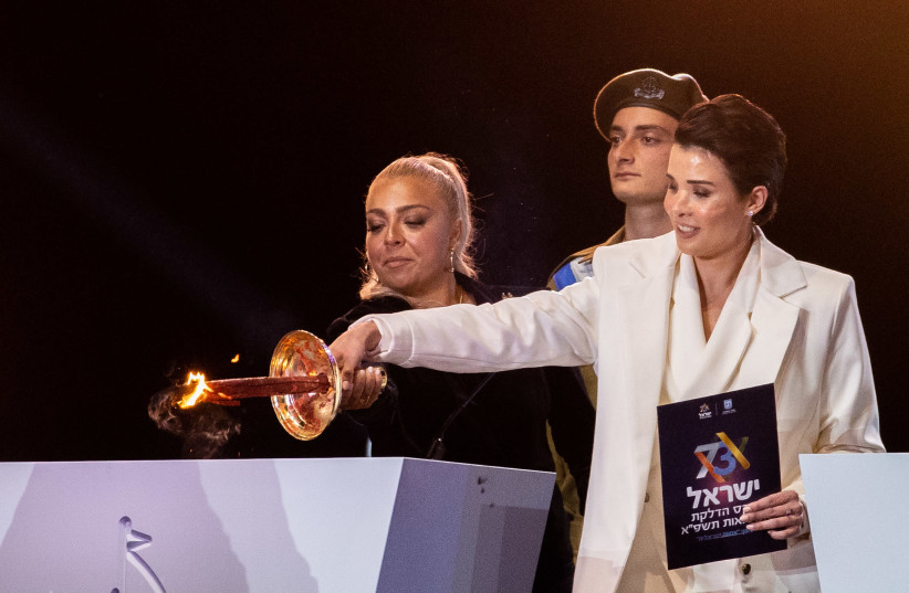 Shira Isakov and Adi Guzi light a torch during the 73rd anniversary Independence Day ceremony, held at Mount Herzl, Jerusalem on April 14, 2021. (credit: YONATAN SINDEL/FLASH 90)