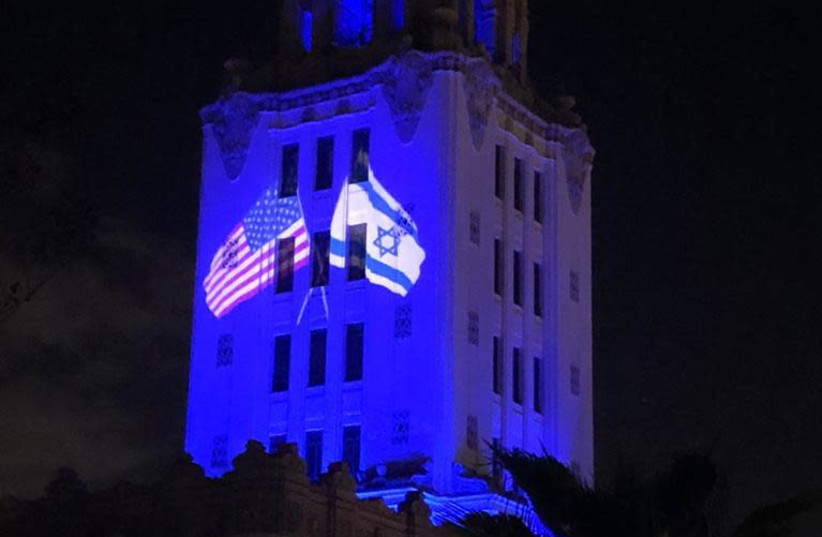 The Beverly Hills City Hall building lights up in blue, and shines an American and Israeli flag intertwined, in honor and celebration of Israel's 73rd Indepenedence Day, April 15, 2021.  (photo credit: FOREIGN MINISTRY)