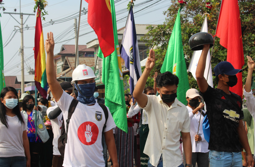 Demonstrators flash a three-finger salute during a protest against the military coup in Dawei, Myanmar April 13, 2021. Courtesy of Dawei Watch/via REUTERS (photo credit: COURTESY OF DAWEI WATCH/VIA REUTERS)