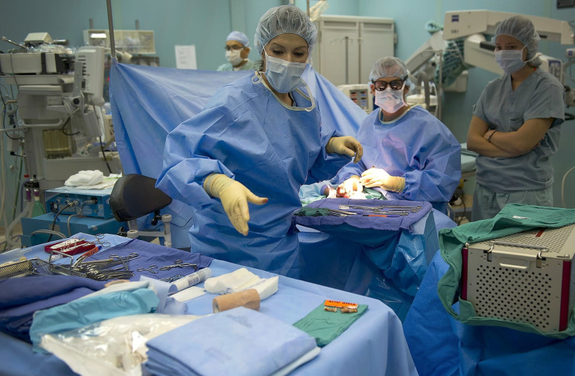 Plastic surgery procedure being performed in an operating room. (credit: Courtesy)
