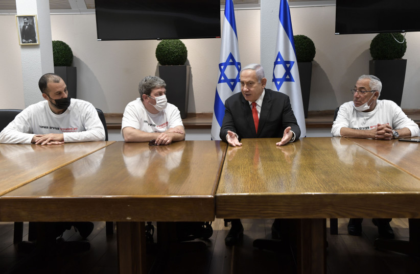 Prime Minister Benjamin Netanyahu meeting with Idan Kleiman, head of the IDF disabled veterans organization in Tel Aviv, April 18, 2021.  (credit: KOBI GIDEON/GPO)
