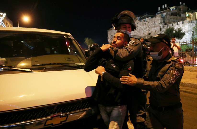 Israeli border police clash with Palestinians outside Damascus Gate in Jerusalem's Old City, April 15, 2021. (photo credit: JAMAL AWAD/FLASH90)