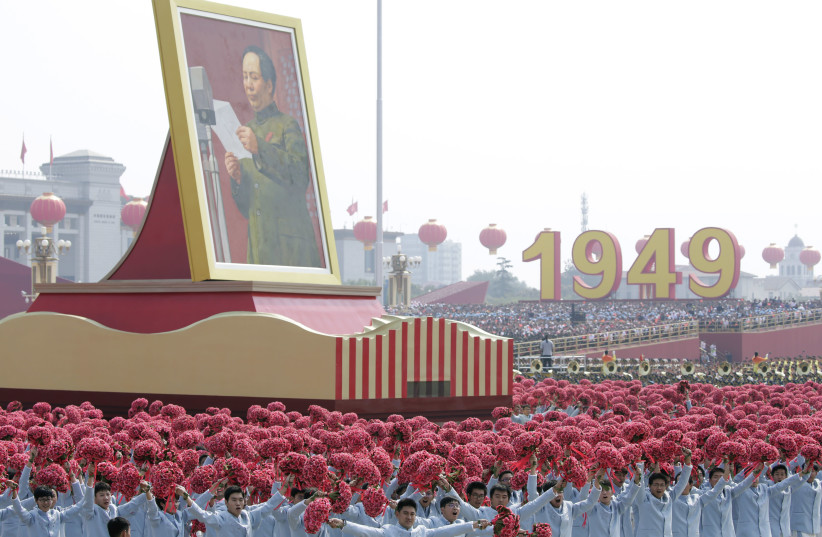 Performers travel past Tiananmen Square next to a float showing late Chinese chairman Mao Zedong during the parade marking the 70th founding anniversary of People's Republic of China, on its National Day in Beijing, China October 1, 2019 (credit: REUTERS/JASON LEE)