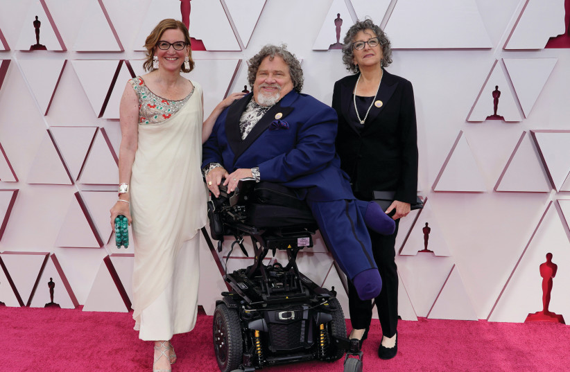FROM LEFT: ‘Crip Camp’ co-directors and co-producers Nicole Newnham and disability rights activist James LeBrecht, and producer Sara Bolder arrive for the 93rd Academy Awards at Union Station in Los Angeles, California, on Sunday. (photo credit: CHRIS PIZZELLO/POOL VIA REUTERS)