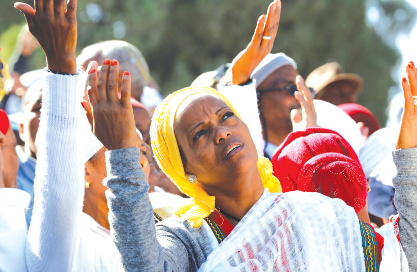AN ISRAELI ETHIOPIAN woman prays during a ceremony marking the holiday of Sigd, in Jerusalem in 2019. (photo credit: CORINNA KERN/REUTERS)