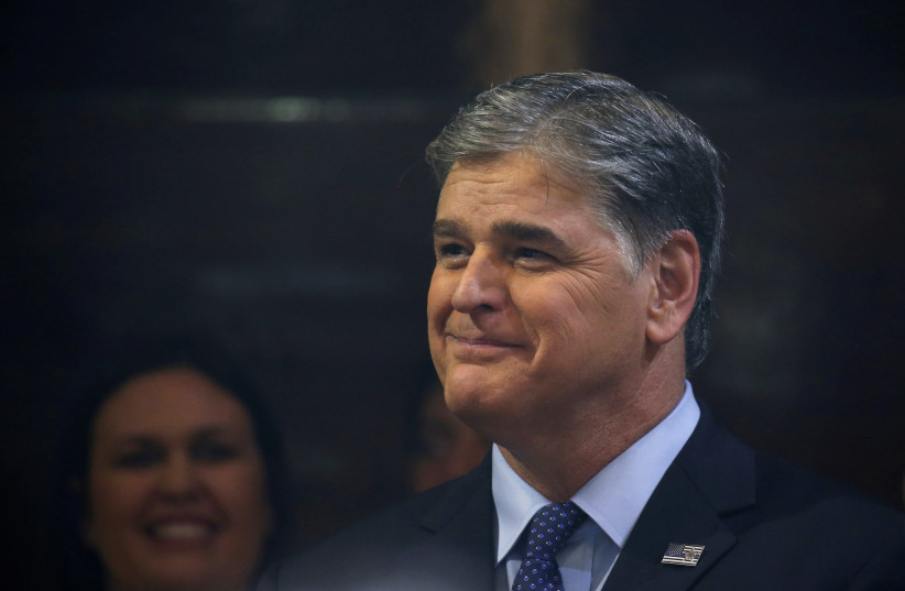 Sean Hannity from Fox News looks on as U.S. President Donald Trump holds a news conference after his summit with North Korean leader Kim Jong Un at the JW Marriott hotel in Hanoi, Vietnam, February 28, 2019.  (photo credit: REUTERS/LEAH MILLIS)