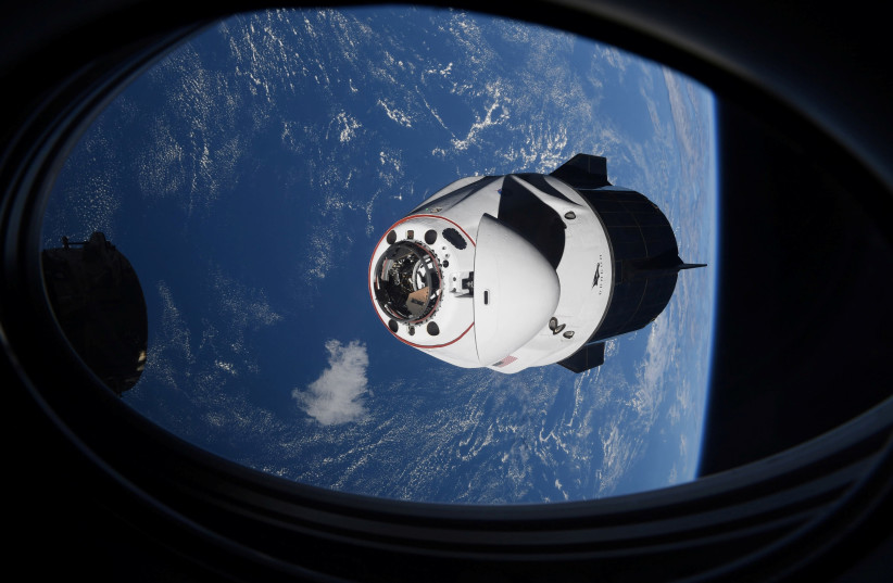 The SpaceX Crew Dragon capsule Endeavor, carrying four astronauts, approaches the International Space Station orbiting the Earth (credit: MIKE HOPKINS/NASA/HANDOUT VIA REUTERS)