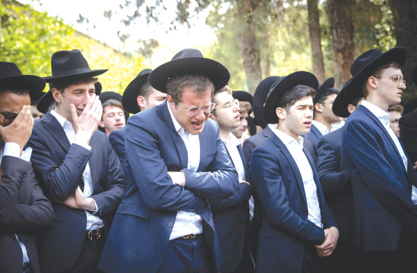 MOURNERS AT the funeral of Abraham Ambon, one of the victims of the Meron tragedy, where 45 people were crushed to death and about 150 injured, during a Lag Ba’omer mass event. (photo credit: YONATAN SINDEL/FLASH90)
