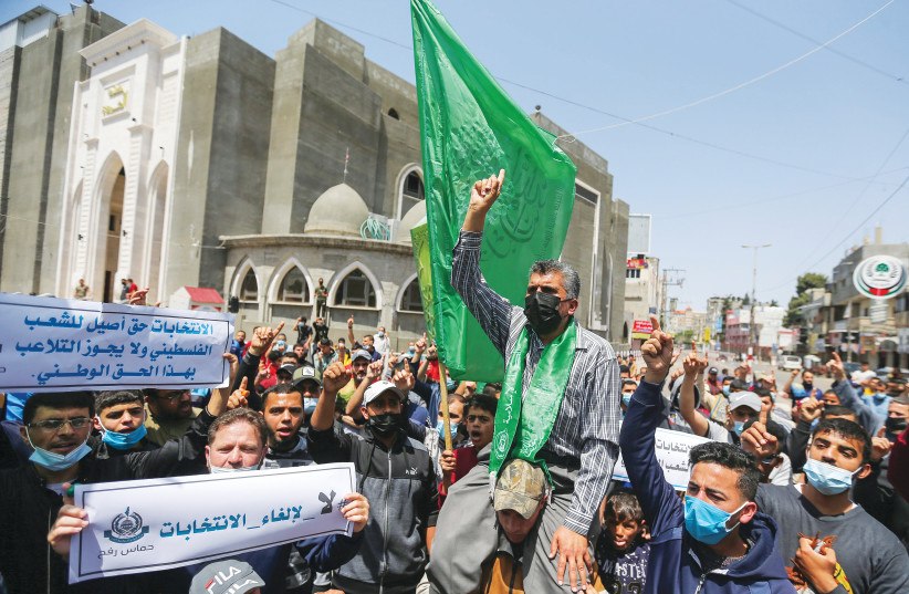 Les sympathisants du HAMAS à Gaza participent à une manifestation contre la décision du président de l'Autorité palestinienne Mahmoud Abbas de reporter les élections législatives, la semaine dernière.  (crédit photo : IBRAHEEM ABU MUSTAFA/REUTERS)