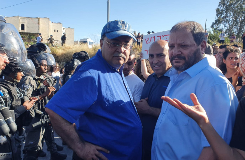 Joint List MK Ofer Cassif and MK Ahmad Tibi face Border Police officers in Sheikh Jarrah, May 7, 2021.  (credit: JOINT LIST)