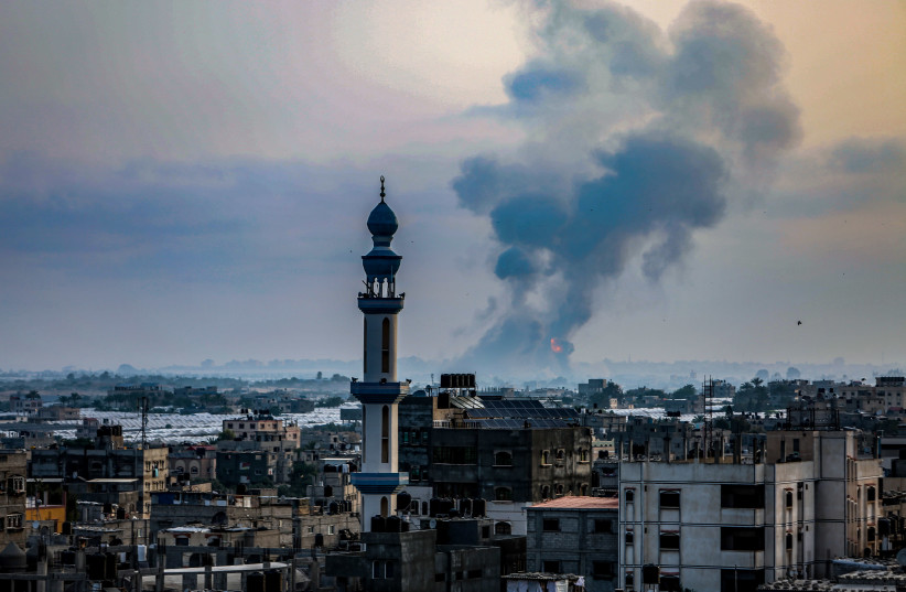 Smoke and flames rise after an Israeli airstrike in a site of the Izz al-Din al-Qassam Brigades, the armed wing of Hamas, in the west of Khan Yunis, in the southern Gaza Strip, on May 11, 2021. (photo credit: ABED RAHIM KHATIB/FLASH90)