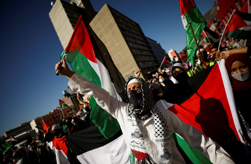 South African demonstrators carry placards during a protest following clashes between Palestinians and Israeli police at Al Asqa Mosque in Jerusalem, outside parliament in Cape Town, South Africa, May 11, 2021. (credit: MIKE HUTCHINGS / REUTERS)