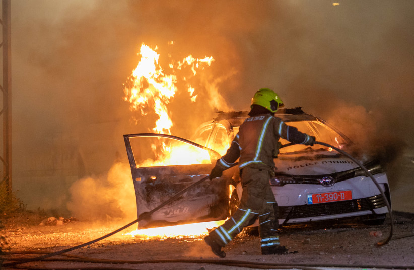 Israeli police seen on the streets of the central Israeli city of Lod, where last night synagogues and cars were torched as well as shops damaged, by Arab residents rioting in the city, still ongoing this evening. May 12, 2021 (photo credit: YOSSI ALONI/FLASH90)