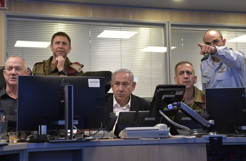Defense Minister Benny Gantz,  Chief of Staff Lt.-Gen. Aviv Kohavi, and Prime Minister Benjamin Netanyahu, arrive at the IDF's Airforce control room in the Kirya military headquarters in order to oversee the IDF's extensive attacks on Hamas's tunnel system.  (photo credit: GPO/KOBI GIDEON)