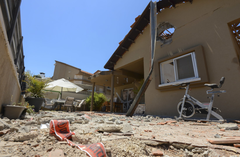 Damage to a house in the Israeli city of Sderot which was hit by rockets fired by Hamas militants in Gaza, into Israel. May 15, 2021. (credit: AVI ROCCAH/FLASH90)