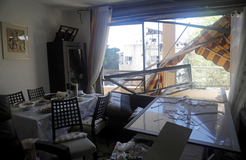A damaged interior at a residential building is seen after a rocket fired from Gaza landed in Ramat Gan, near Tel Aviv, Israel May 15, 2021. (photo credit: NIR ELIAS / REUTERS)